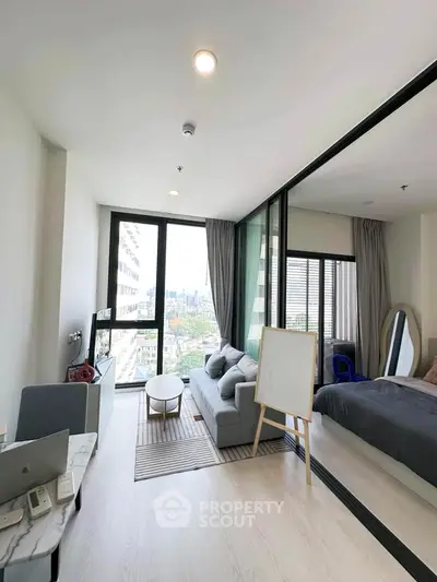 Modern living room with city view, featuring sleek furniture and floor-to-ceiling windows in a stylish apartment.