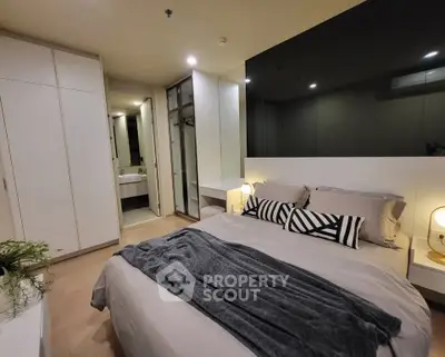 Modern bedroom with stylish decor and cozy ambiance, featuring a comfortable bed and ample storage space.
