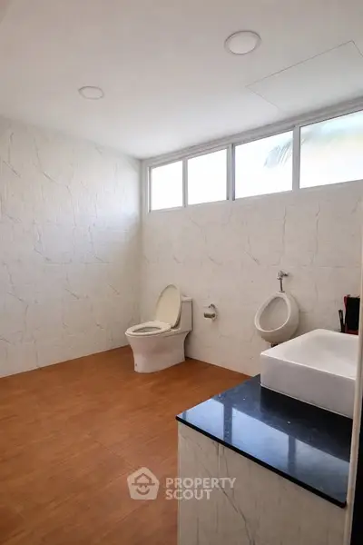Spacious modern bathroom with elegant fixtures and natural light