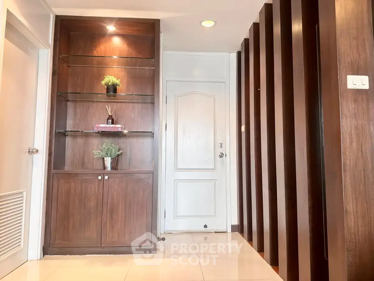 Elegant hallway with wooden shelving and modern decor in a stylish home