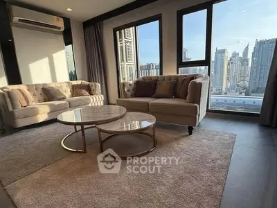 Luxurious living room with city view, elegant sofas, and modern decor.