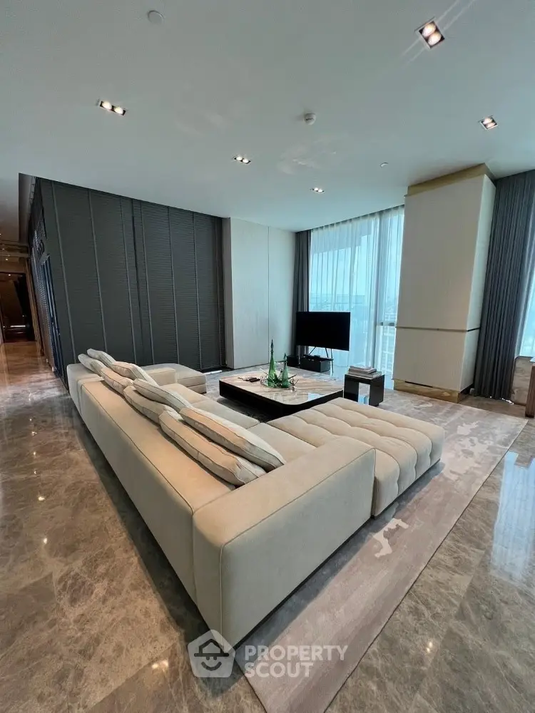 Luxurious modern living room with plush sectional sofa and panoramic city views