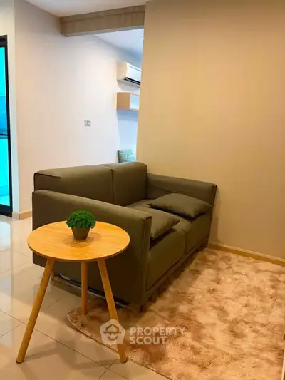 Cozy living room with modern sofa and stylish side table on plush rug