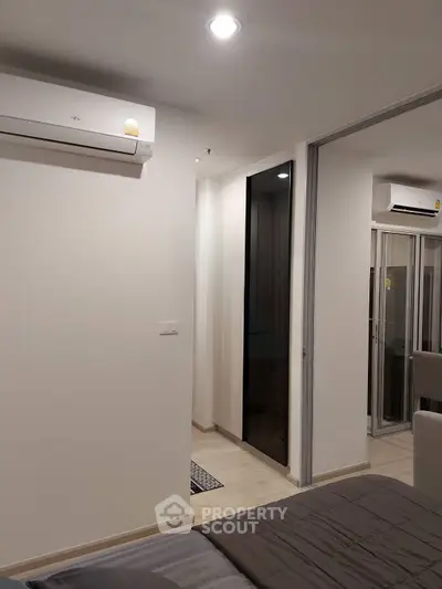 Modern bedroom with air conditioning and sliding door in a stylish apartment.
