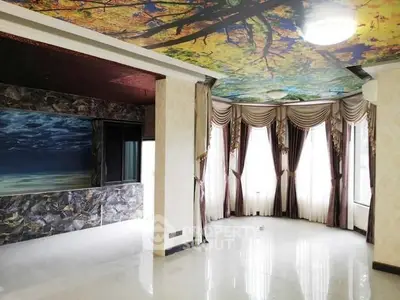 Luxurious living room with artistic ceiling and elegant drapery