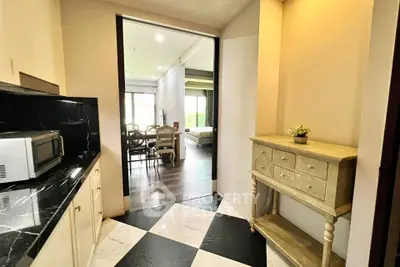 Chic apartment interior with stylish hallway leading to a cozy living area, featuring elegant flooring and modern decor.