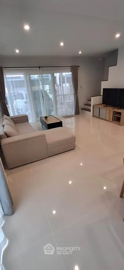 Spacious modern living room with sleek design and ample natural light