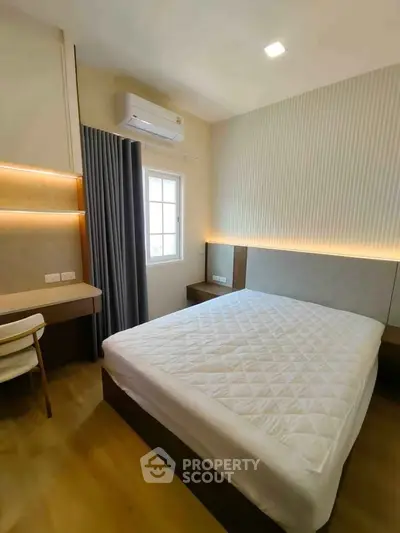 Modern bedroom with stylish decor, featuring a comfortable bed and elegant lighting, perfect for relaxation.