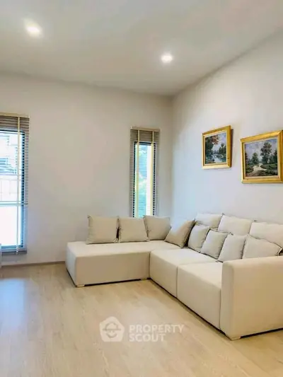 Modern living room with cozy beige sectional sofa and elegant decor.
