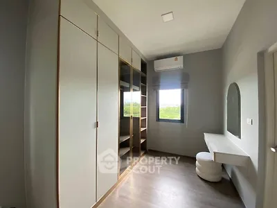 Modern bedroom with built-in wardrobe and stylish vanity area