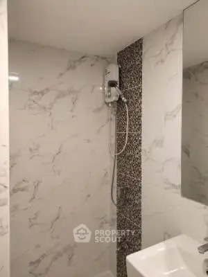 Modern bathroom with marble tiles and sleek shower design