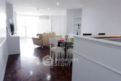 Spacious open-plan living and dining area with modern furnishings and natural light.