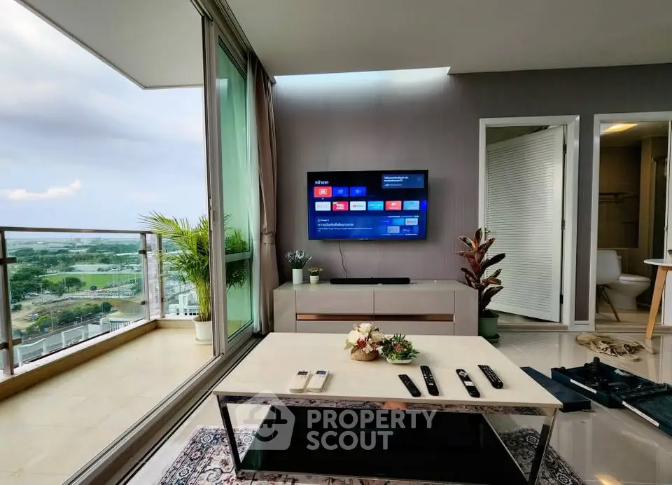Modern living room with balcony view and wall-mounted TV