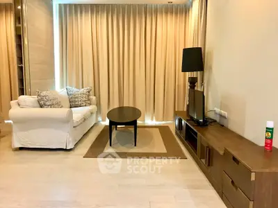 Modern living room with cozy sofa, stylish lamp, and sleek TV stand in a bright, inviting space.