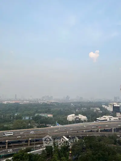 Stunning cityscape view from high-rise building overlooking highway and skyline.