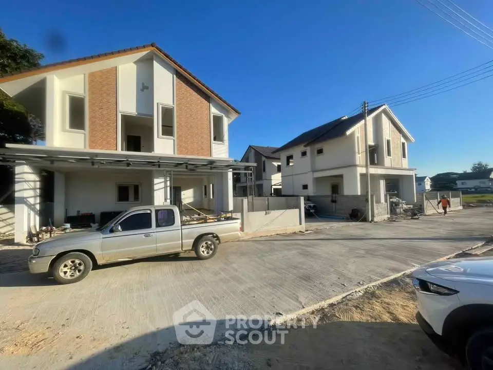 Modern residential houses with spacious driveway and clear blue sky