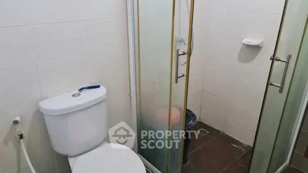 Compact bathroom with shower and toilet in modern apartment