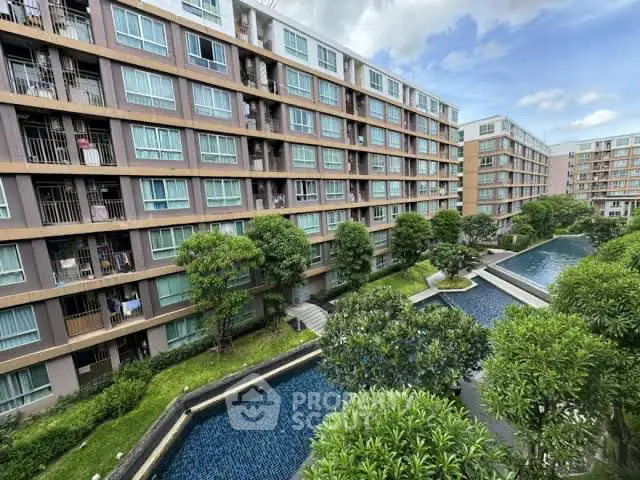 Modern apartment complex with lush gardens and serene water features