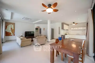Spacious open-plan living and dining area with modern furnishings and ceiling fans.