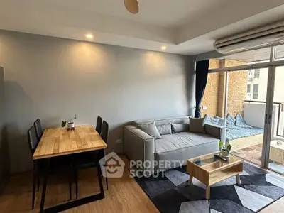 Modern living room with stylish furniture and balcony access