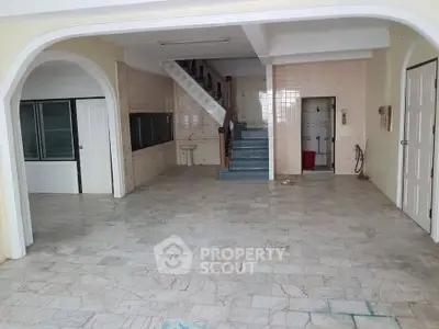 Spacious interior with marble flooring and staircase, ideal for customization.
