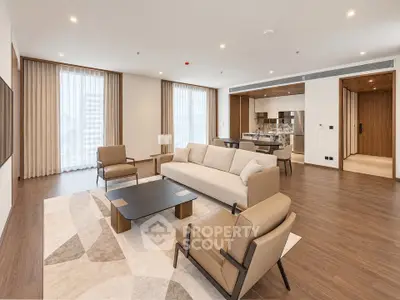Spacious modern living room with elegant furniture and open kitchen layout in luxury apartment.