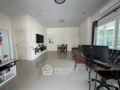 Spacious modern living room with sleek furniture and natural light, perfect for family gatherings.