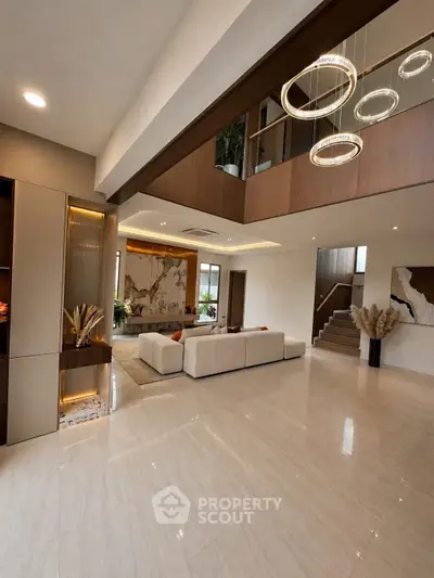 Luxurious modern living room with high ceilings and elegant lighting fixtures