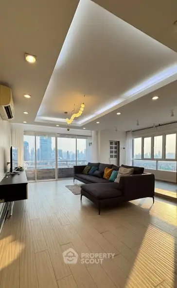 Spacious modern living room with stunning city view and elegant lighting
