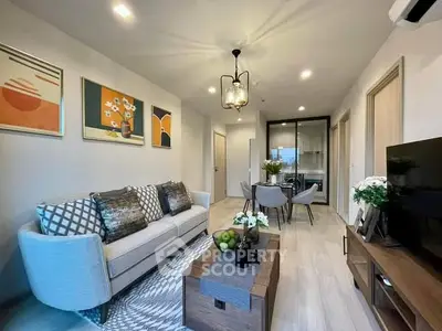 Modern living room with stylish decor and open dining area, perfect for entertaining.