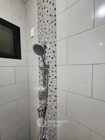 Modern bathroom shower with stylish tile design and sleek fixtures