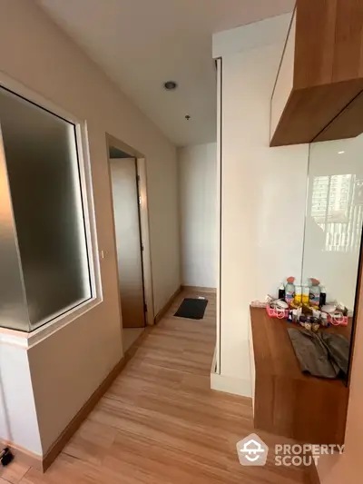 Modern hallway with wooden flooring and built-in storage