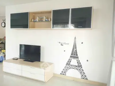 Modern living room with stylish wall decor and sleek TV unit