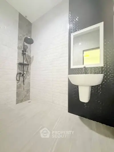 Modern bathroom with sleek black and white tiles and stylish fixtures