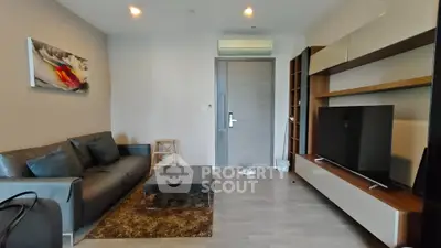 Modern living room with sleek furniture and stylish decor in a contemporary apartment.