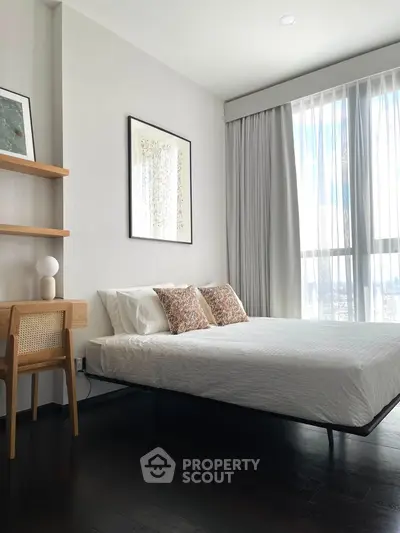 Modern bedroom with large window and stylish decor in a high-rise apartment.