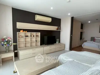 Spacious modern living room with stylish furniture and cozy bedroom area