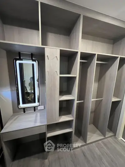 Spacious walk-in closet with modern shelving and vanity mirror