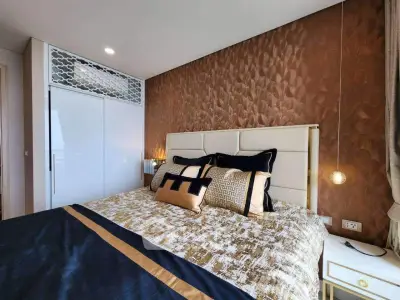 Luxurious bedroom with elegant decor and plush bedding in modern apartment.