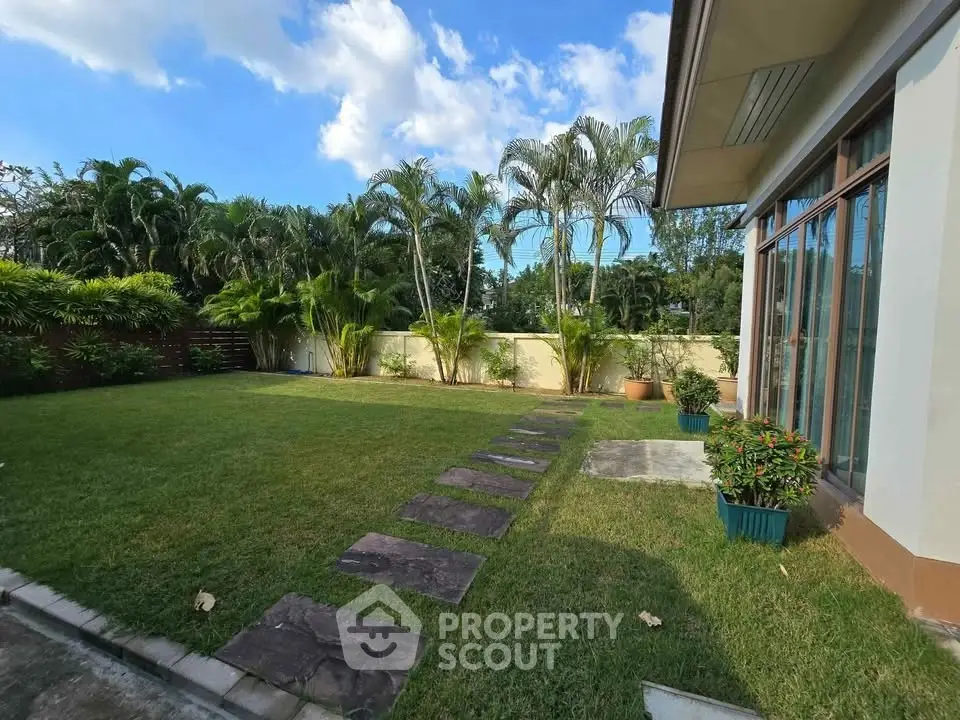 Spacious garden with lush greenery and modern house exterior