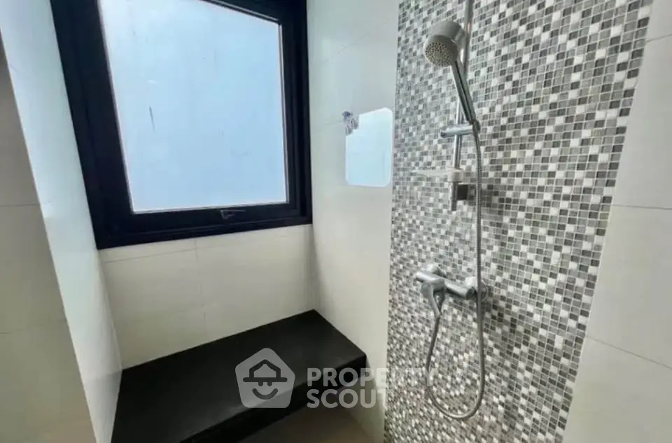 Modern bathroom with stylish shower and mosaic tile design
