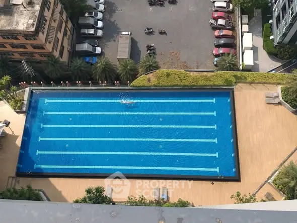 Stunning aerial view of a luxurious swimming pool in a modern residential complex.