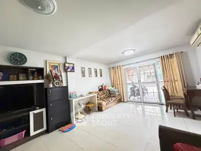 Spacious living room with modern decor and large windows for natural light.