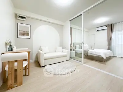 Modern studio apartment with cozy living area and stylish bedroom