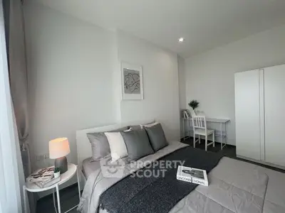 Modern bedroom with stylish decor and cozy ambiance, featuring a comfortable bed and sleek furniture.