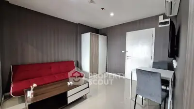 Modern living room with red sofa, sleek furniture, and minimalist decor