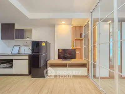 Modern living room with open kitchen and sleek design in a contemporary apartment.