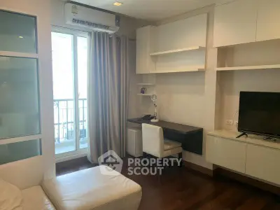 Modern living room with study area and balcony access in a stylish apartment.