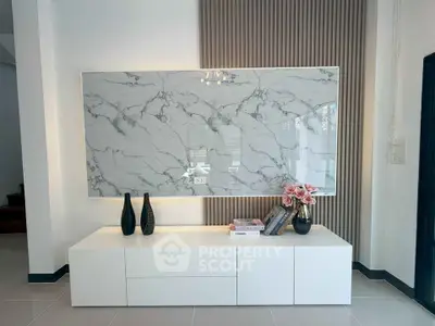 Elegant modern living room with marble accent wall and stylish decor