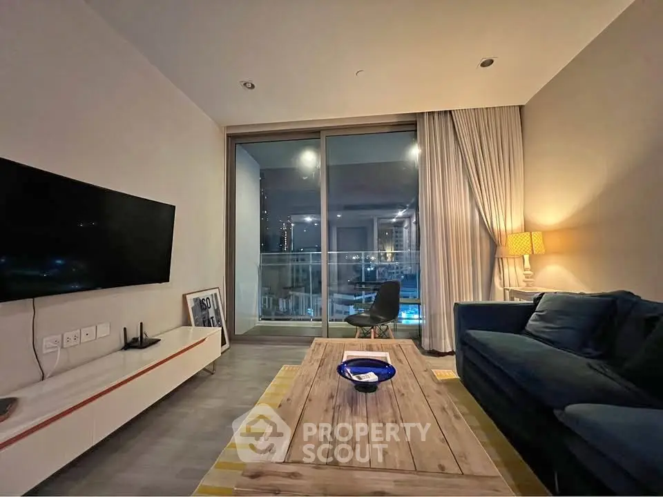 Modern living room with cozy sofa, stylish decor, and large window offering city view.